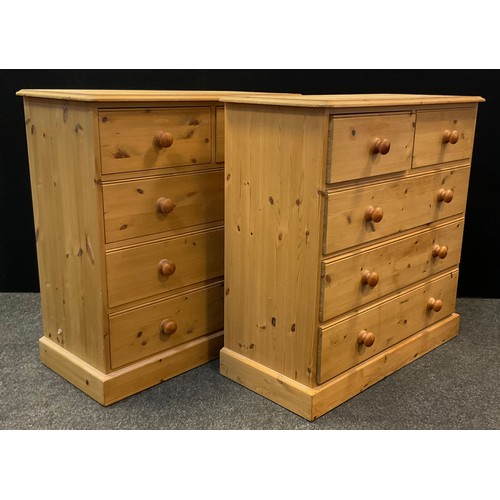 23 - A pair of pine five drawer chests, each with rounded oversailing tops, two short over three long dra... 