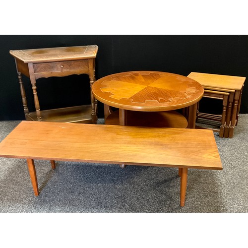 194 - A mid 20th century teak Nathan Cog circular coffee table, geared wheel quartered top, shelf undertie... 