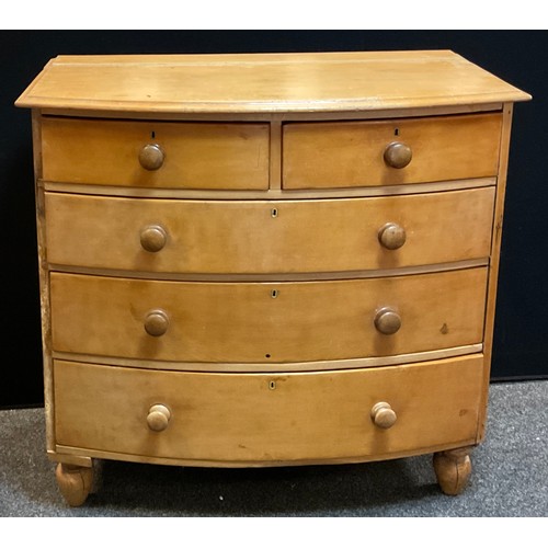 196 - A Victorian pine Bowfront chest of two short over three long drawers, turned feet, 107cm high, 113cm... 