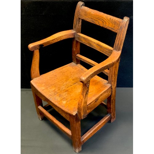 199 - A 19th century child’s elm open armchair, 55cm high x 36.5cm wide.