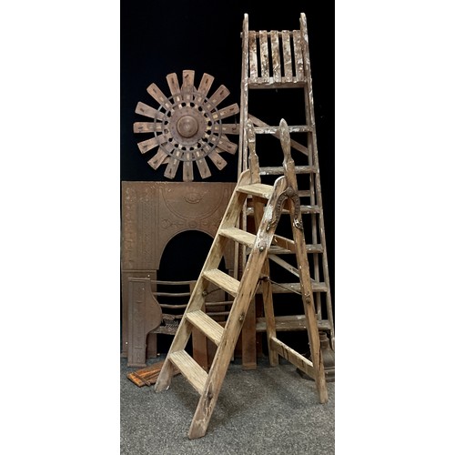 200 - A pair of wooden six step folding ladders;  another smaller;   cast iron fire back;  wooden and meta... 