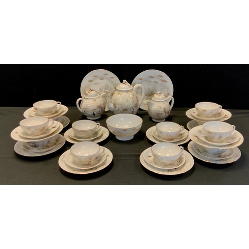 147 - A Japanese egg shell porcelain tea set - Decorated witty figures in landscape, printed marks.