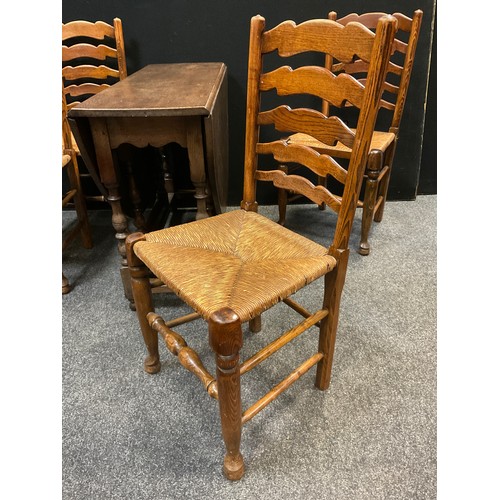 207 - A set of four 19th century elm ladder-back chairs, rush seats, turned legs and stretchers;  a confor... 