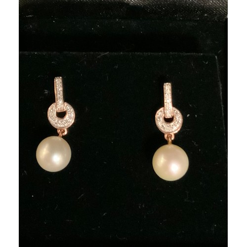 251 - A pair of diamond and pearl rose gold earrings, rose gold bar and loop drops, accented with sixteen ... 