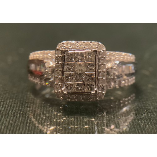 313 - A diamond cluster ring, pave set with eighty princess, baguette and round brilliant cut diamonds, to... 