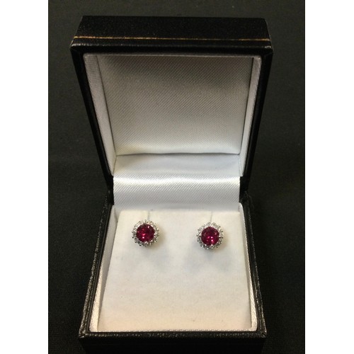 315 - A pair of ruby and diamond effect CZ cluster earrings, silver mounts, stamped 925.