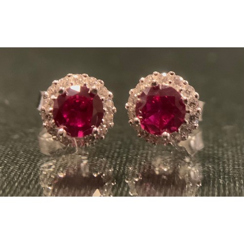 315 - A pair of ruby and diamond effect CZ cluster earrings, silver mounts, stamped 925.