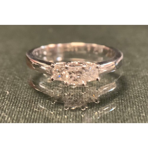 266 - A diamond ring, with three stepped princess cut diamonds, total estimated diamond weight approx 0.52... 