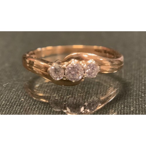 261 - A diamond three stone ring, grooved and twisting top, set with three round brilliant cut diamonds, t... 