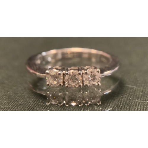 252 - A diamond ring, set with three round brilliant certified diamonds, colour F-G, clarity SI2, total di... 