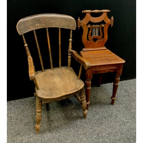 73A - A carved pitch pine lyre back hall chair, bone string detailing, turned fore legs, 79cm high, 44cm s... 