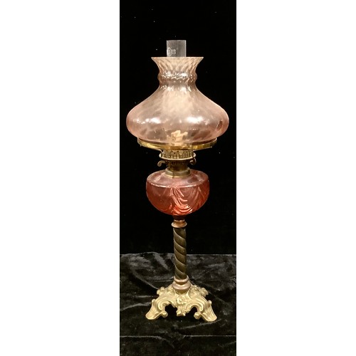 39 - A late 19th century oil lamp, cranberry glass reservoir, pink tinged shade, Duplex twin burner, barl... 