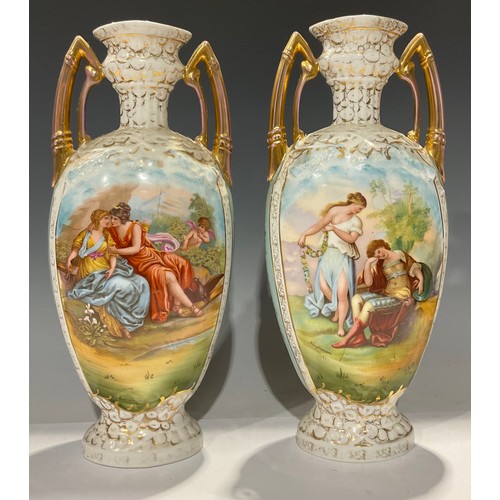 67 - A pair of Sitzendorf flattened ovoid two handled pedestal vases, transfer printed with cupids and ot... 