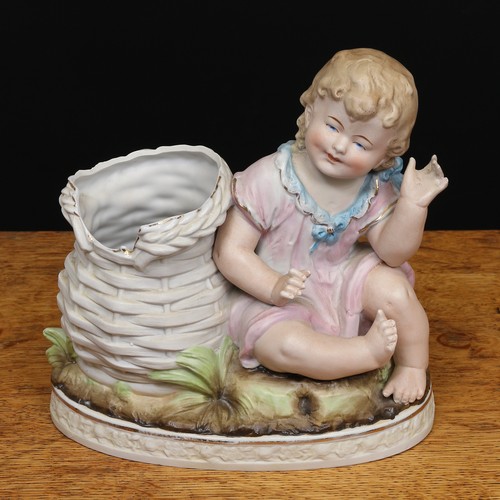 68 - A late 19th century German bisque piano baby spill vase, modelled as a seated young girl alongside a... 