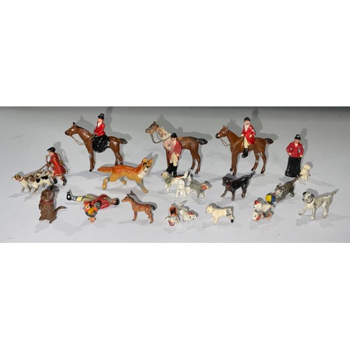 72 - A collection of painted lead figures and animals, including huntsmen, hounds, cat and ball, begging ... 