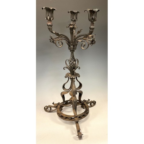 77 - An elaborate Art Nouveau three branch candelabra, wrought and cast iron scrolling column, tripod fee... 