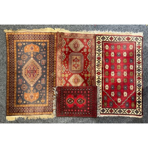 82 - A Middle Eastern rectangular woollen rug or carpet, stylised geometric floral motifs, in tones of re... 