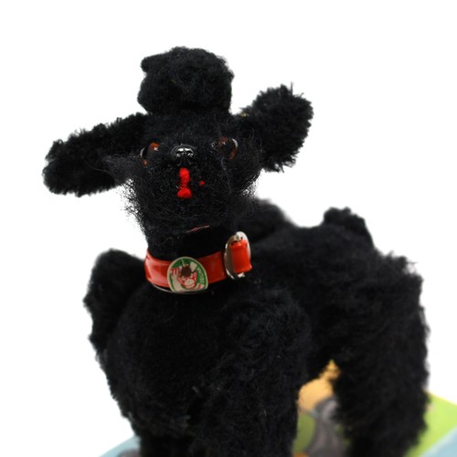 124 - Toys & Juvenalia - a West German 501 black flock covered novelty clockwork toy, in the form of a Poo... 