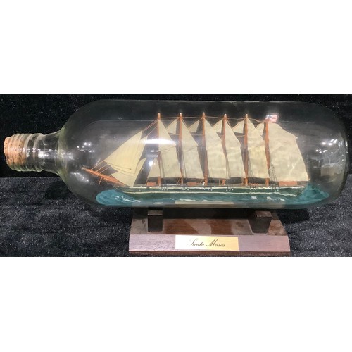 245 - Maritime Interest - an early 20th century ship in a bottle, as a steam barge, 26cm long; another, as... 