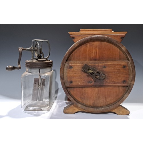 421 - An early 20th century pine butter churn and cover, 40cm high; a glass butter churn (2)