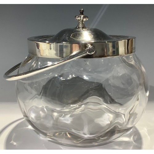 428 - A George V silver and clear glass biscuit barrel, swing handled, domed cover with spire finial, 19cm... 