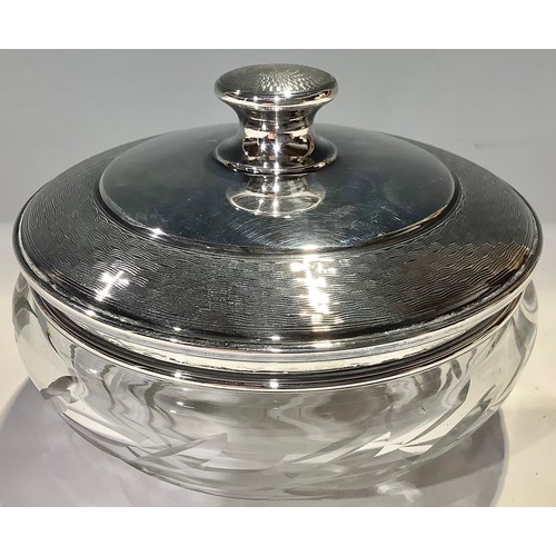 429 - A George V silver and clear glass powder bowl the domed silver cover engine turned, 11cm diameter, B... 