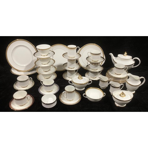 472 - A Royal Doulton Royal Gold part dinner and tea service, comprising teapot, cake plates, dinner plate... 