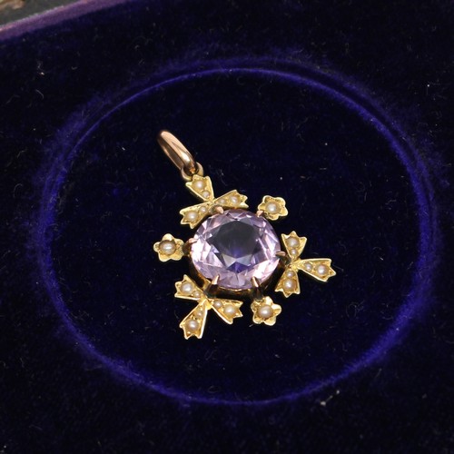 480 - An Edwardian 16ct gold pendant, set with a single faceted amethyst, the border flanked with seed pea... 