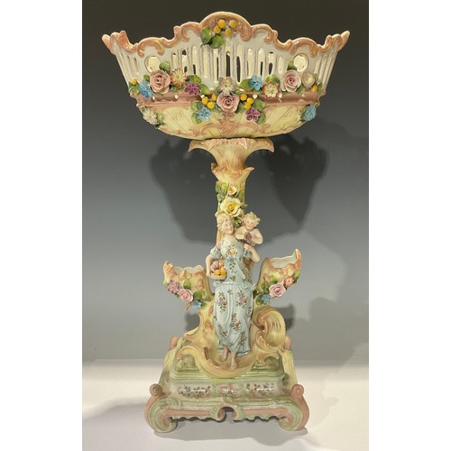 490 - A late 19th century German porcelain table centre, pierced floral encrusted basket, figural support ... 