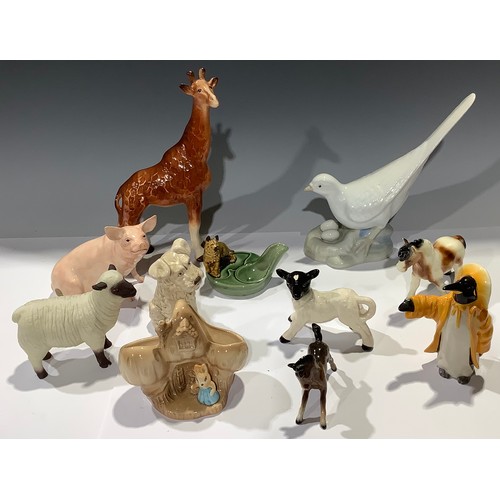 492 - A John Beswick model of a pig; a John Beswick Penguin in a yellow mac and Sou'wester; a Melba giraff... 