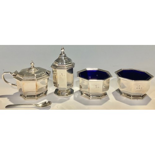 500 - A silver four piece condiment set, comprising a pair of salts, pepper and mustard, blue glass liners... 