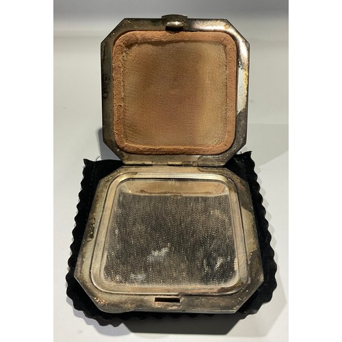 501 - A silver and engine turned white enamel canted square compact, decorated with cornflowers, hinged co... 