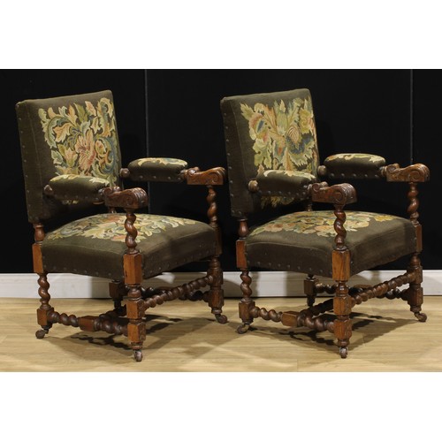 103 - A pair of late Victorian oak Baronial type armchairs, 100cm high, 68cm wide, the seat 53cm wide and ... 