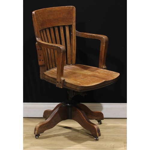 119 - An early 20th century oak swivel desk chair, 92.5cm high, 57cm wide, the seat 47.5cm wide and 44.5cm... 