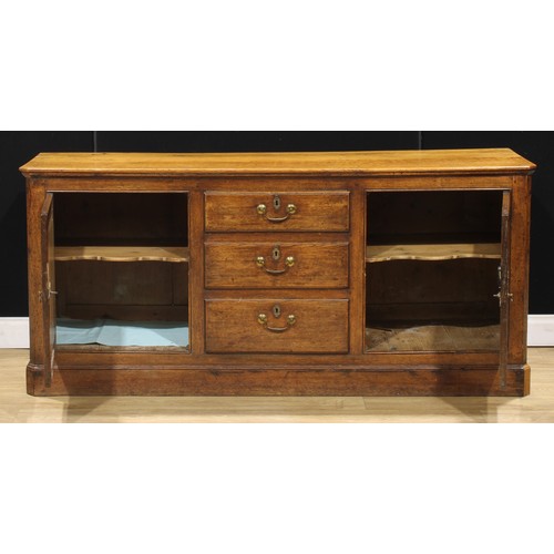 205 - A 19th century oak low dresser, slightly oversailing top above three short drawers flanked by panel ... 