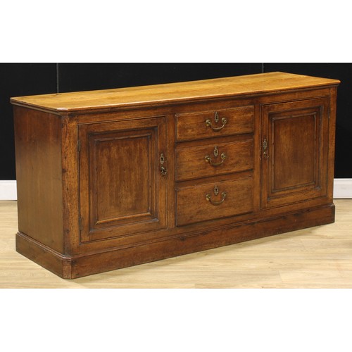 205 - A 19th century oak low dresser, slightly oversailing top above three short drawers flanked by panel ... 