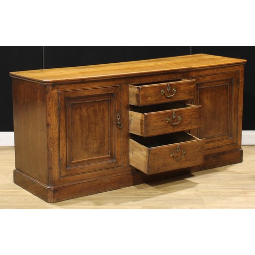 205 - A 19th century oak low dresser, slightly oversailing top above three short drawers flanked by panel ... 