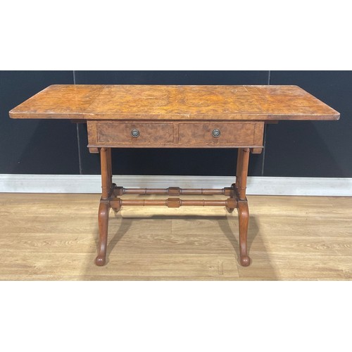 409 - A walnut and mahogany sofa table, rounded rectangular top with fall leaves above a pair of frieze dr... 