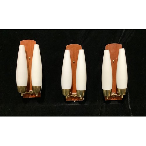 673 - A pair of mid-20th century wall lights, opaque frosted white glass, teak back boards, two other pair... 