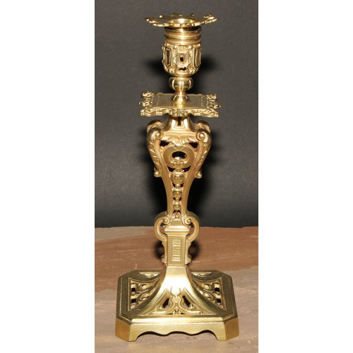 520A - A pair of French gilt brass table candlesticks, cast throughout with scrolls and acanthus, canted sq... 