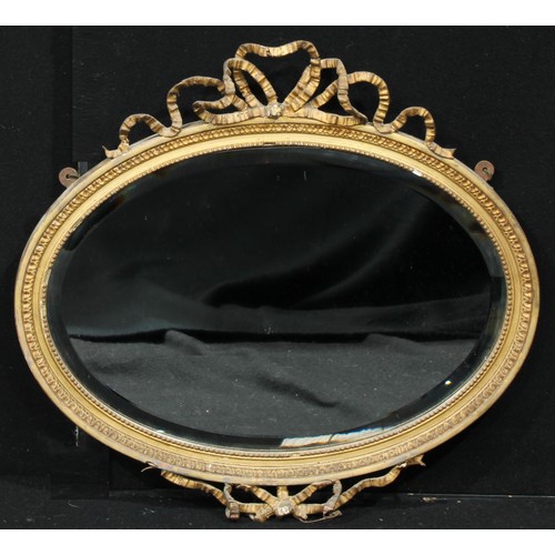 525A - A 19th century oval giltwood and gesso pier glass, bevelled mirror plate, the frame applied with a r... 