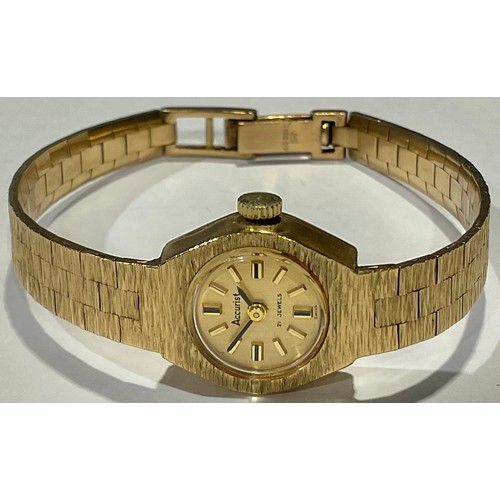 748 - A lady's 9ct gold Accurist watch, gilt dial with baton indicators, integral 9ct gold textured bark b... 