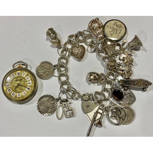 755 - A silver charm bracelet, London 1979, various silver and other charms, 70.5g gross; a lady's fob wat... 