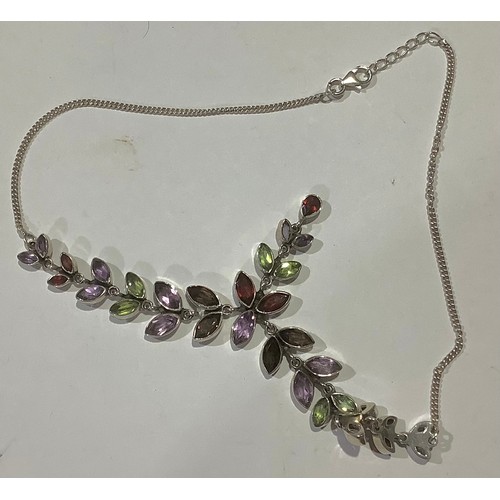 775 - A silver and multi gemstone necklace, set with navette and pear shaped garnets, amethyst, and perido... 