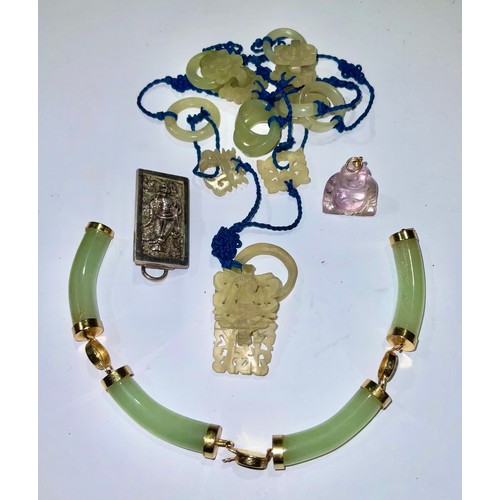 778 - A Chinese jade pendant; a hardstone Buddha fob; a bangle (a/f); a silver brooch