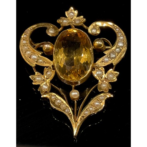 783 - An Edwardian citrine and seed pearl brooch, stamped '9ct', the central large oval citrine 16mm high,... 