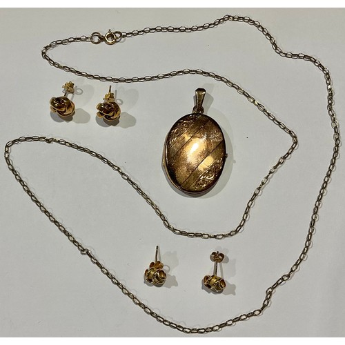 785 - A 9ct gold locket and chain; a pair of 9ct gold earrings; another pair; 11g gross