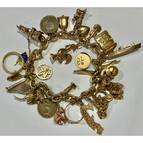 795 - A 9ct gold curb link charm bracelet, assorted 9ct gold charms including, ape, cruise ship, horse and... 