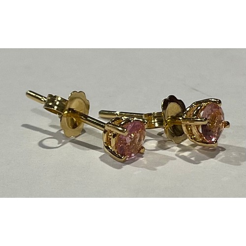 808 - A pair of gold coloured metal ear studs set with brilliant cut pink stones, stamped '750' for 18ct g... 