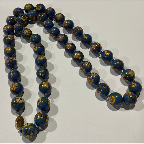 809 - A string of 44 spherical cloisonne beads, each in blue with flowering stems